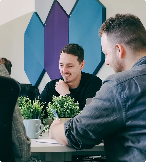 Two members of the Darwin team in a meeting at a desk
